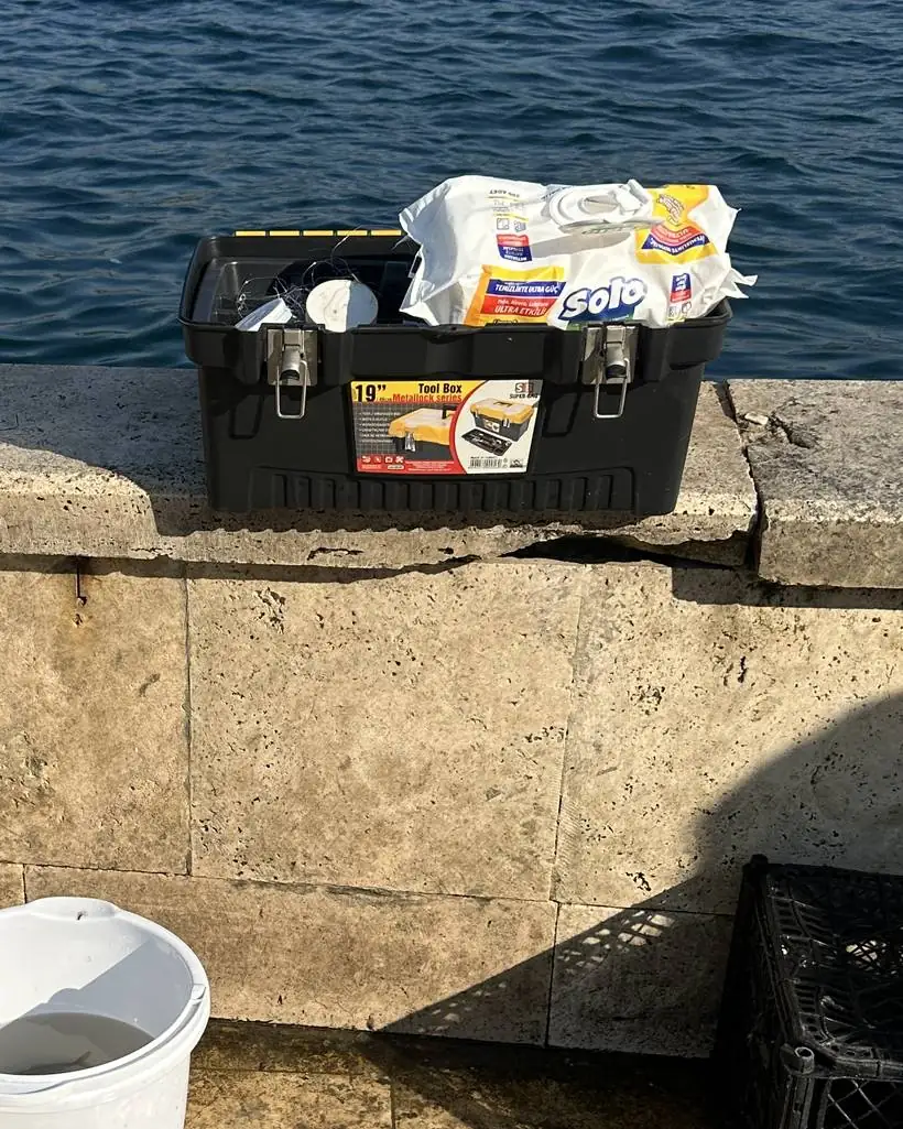 Tackle box and rod set up on the quay wall